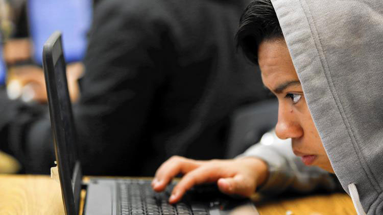 Thomas Navas, 16, a student in the Introduction to Data Science class at Francis Polytechnic High, uses data from the Centers for Disease Control to test his theory that there is a relationship between hours of sleep per night and a person's height. (Patrick T. Fallon / For the Los Angeles Times)